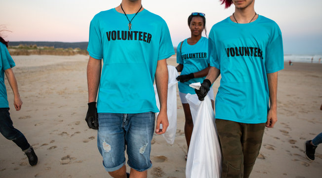 Volunteers carrying trash bags