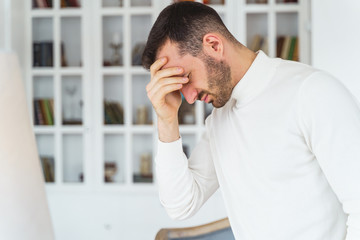 Young man suffering from a severe headache