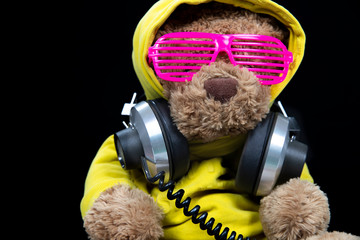 brown teddy bear  in yellow hoodie