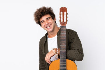 Young caucasian man with guitar over isolated white background