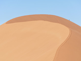People hiking Dune 45 in Sossusvlei area, southern part of the Namib Desert, Namibia