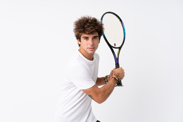 Young caucasian man over isolated white background playing tennis