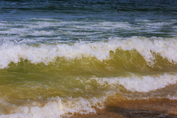 Blue water ocean wave blue swells crashing curling breaking a wavy surface