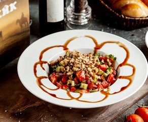 green salad with cucumber tomato parsley walnut and teriyaki sauce