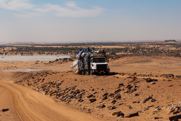 Heavily loaded truck transporting goods parked next to orad in the Sahara desert, Chad, Africa