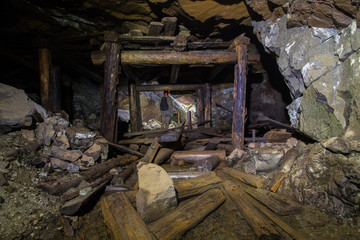 Fototapeta na wymiar Underground abandoned platinum ore mine tunnel collapsed wooden timbering