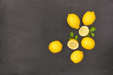 Fresh ripe lemons on dark background. Top view