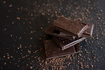 chocolate, dessert, dark chocolate, dark background, pleasure, sweetness, kako, sugar, tablet, cube, celebration, gift, closeup, chocolate on dark background, front view, image, chocolate, cream, hard