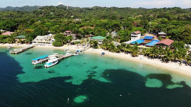 Docked boats on Honduras coastline, aerial
