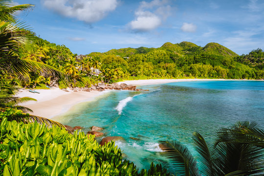 Mahe Island, Seychelles. Holiday vocation on the beautiful exotic Anse intendance tropical beach. Ocean wave rolling towards sandy beach with coconut palm trees