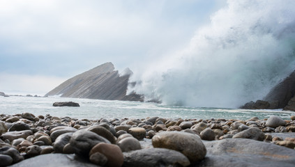 Stones with the waves behind