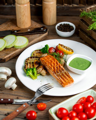 grilled salmon served with grilled zucchini lemon tomato bell peppers mushroom and broccoli