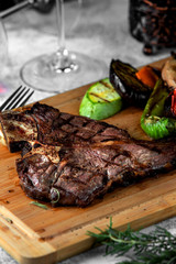 grilled t-bone steak served with grilled vegetables