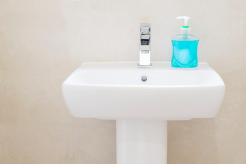 Anti-bacterial blue hand wash on hand basin to prevent coronavirus and other germs or virus 