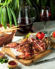 grilled whole chicken served with smoked tomato pepper and fresh onion slices