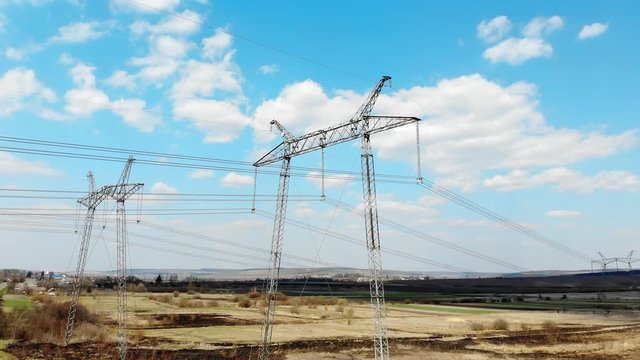 Aerial view Long-distance power transmission lines. High-voltage poles that efficiently transmit thousands of kilovolts of electricity between cities