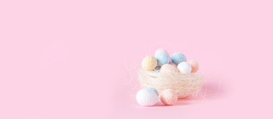 Easter flat lay background of colorful eggs on a pink background, Easter pattern top view with copy space.