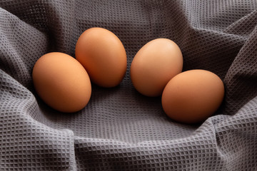 fresh rustic eggs on a background of gray material