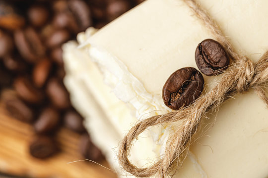 Composition with grains of coffee, soap on the wooden table, close up