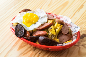 Peruvian salchipapa: hot dog with fried egg and potatoes