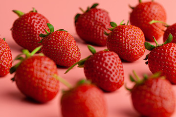 Strawberry on pink background. Creative food concept. Close up.