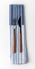 Set of fork and knife on towel. Isolated on white background. Close up.