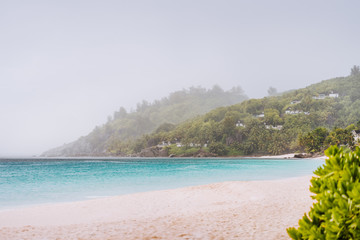 Tropical rain covered Anse Intendance beach on Mahe island in Seychelles