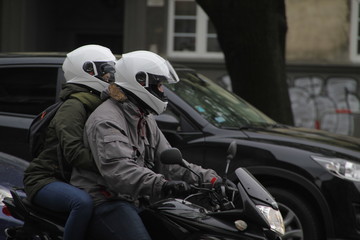 Couple with helmets in a motorbike