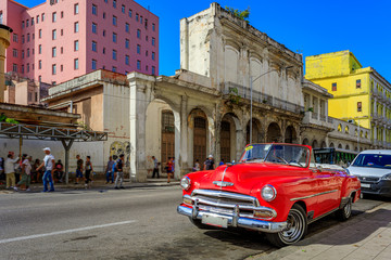 Havana Cuba Red vintage classic american car in a typical colorful street with sunny blue sky 