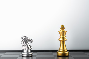 Fototapeta na wymiar golden king chess standing encounter silver knight enemies.