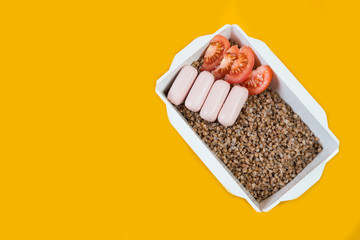 Delivery of ready-made food. Box buckwheat with sausages from the restaurant