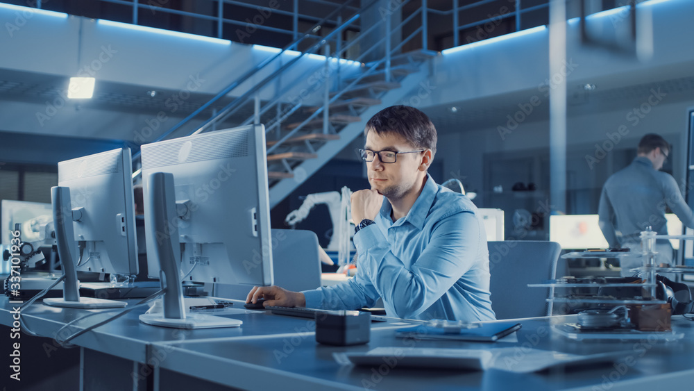 Fototapete Electronics Development Engineer Sitting at His Desk Uses personal Computer for Programming. Team of Professionals Use Digital Whiteboard with CAD Software for the Modern Industrial Engineering Design