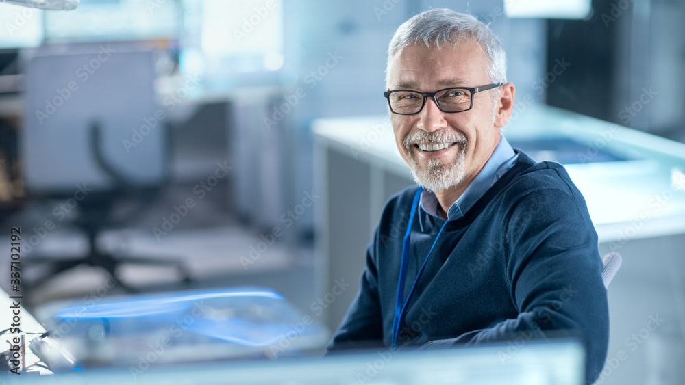 Poster professional electronics design engineer wearing glasses works in research laboratory and smiles on 