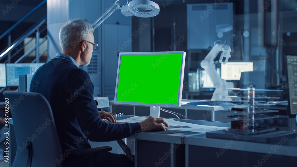 Poster professional heavy industry engineer works on green mock-up screen computer. engineering bureau and 