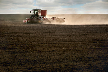 tractor work plow the field with durst . Agricultural works for processing, tillage. Farmers...