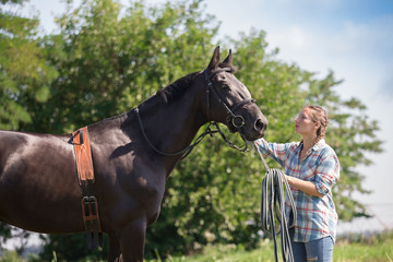 Fototapeta premium Woman and horse, landscape, green field