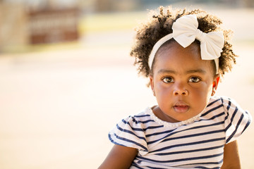 African American little girl looking at the camera.