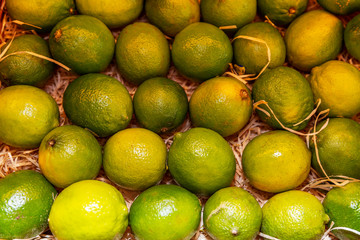Juicy limes on a store counter. Close-up. Top view. Strengthening immunity during the coronavirus pandemic.
