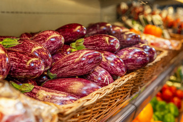 Bright eggplants on a store counter. Close-up. Side view. Vegetarianism and malnutrition.