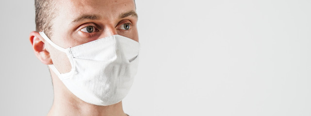 Young man wearing protection face mask against coronavirus banner.