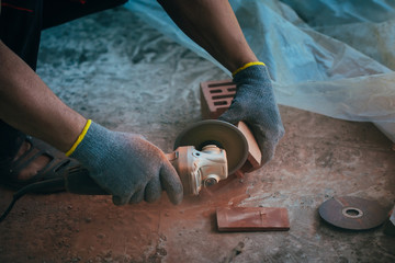 Worker cutting bricks. Close up