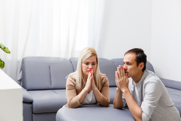 woman and man pray at home