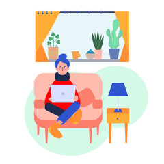 young white woman sitting on coach with laptope