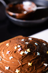 Hot Chocolate cake with sweet decoration butterflies on a domestic kitchen