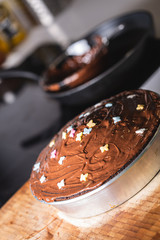 Hot Chocolate cake with sweet decoration butterflies on a domestic kitchen