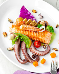 seafood plate with grilled salmon octopus mussels shrimps mushroom and potatoes © Kamran