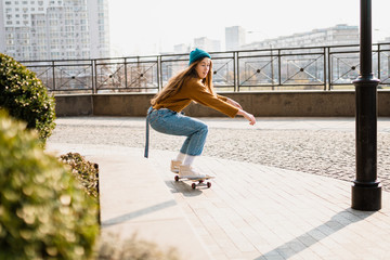 Skateboarding at city. Female, enjoyment. Hipster girl riding skate board. Ride, style. Extreme...