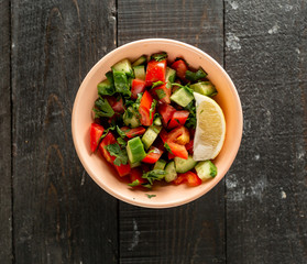 shepherd salad with cucumber tomato herbs garished with lemon