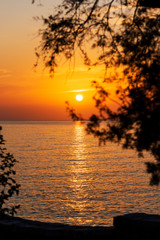 Beautiful wide orange colorful sunset on the sea, peaceful and idyllic