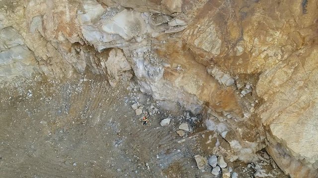 Aerial video footage of a surveyor performing measurements at a quarry	